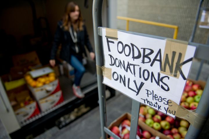 Lovin' Spoonfuls' Meg Kiley loads donated produce onto a truck during a 2013 pickup from Whole Foods. Their group picks up su
